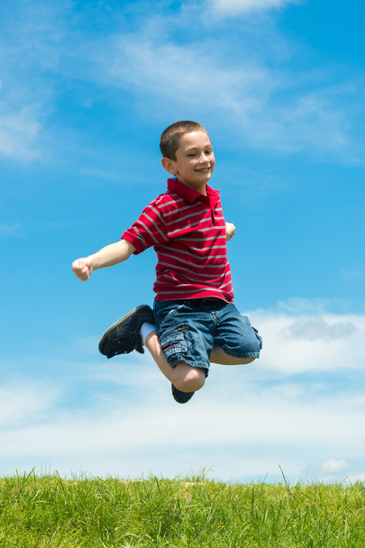 Kid jumping high outdoors - Φωτογραφία, εικόνα