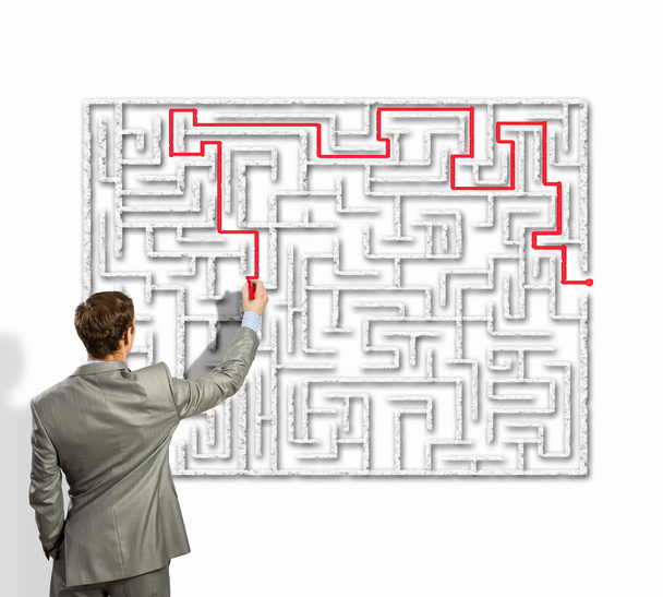 Businessman solving labyrinth problem - 写真・画像