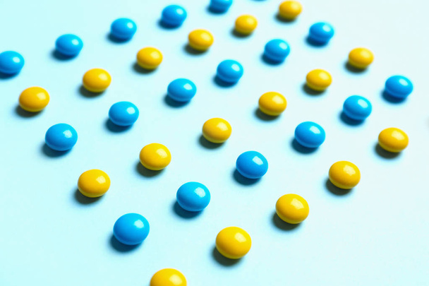 Delicious bright candies on light blue background - Foto, immagini