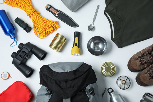 Flat lay composition with different camping equipment on white background - Φωτογραφία, εικόνα
