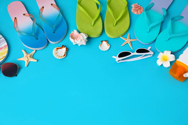 Flat lay composition with different flip flops on blue background, space for text. Summer beach accessories - Фото, изображение