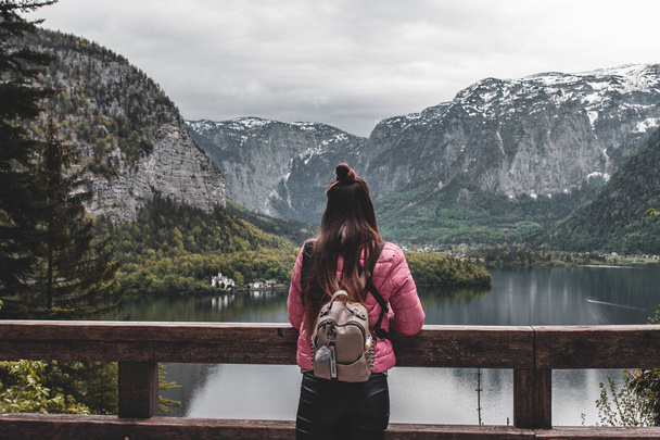 rear view of woman standing on lake shore in Austrian Alps Mountains - Photo, Image