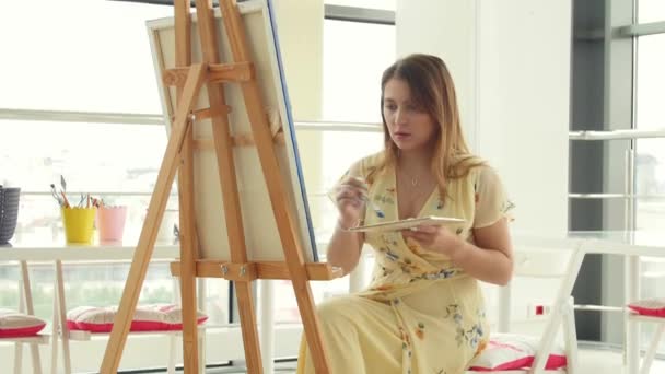 Art, creativity, hobby, job and creative occupation concept. Young cute girl draws in art workshop - Footage, Video