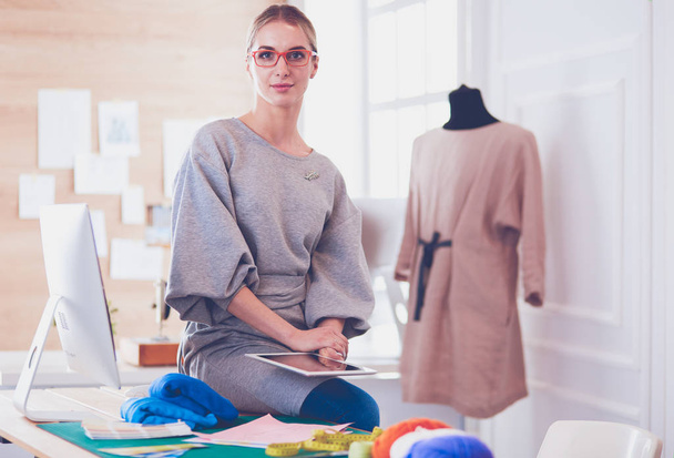 Beautiful fashion woman designer standing in studio - Zdjęcie, obraz