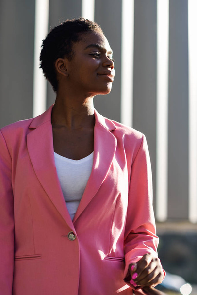 Black businesswoman standing near business office building. - Zdjęcie, obraz
