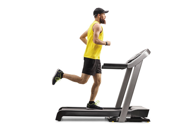 Bearded man running on a treadmill  - Foto, Imagen