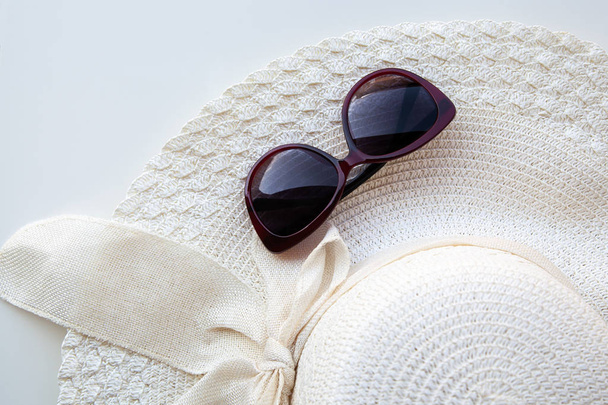 Straw hat with sunglasses on white background - Photo, image