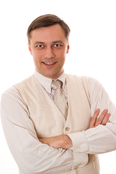 Молодой бизнесмен стоит и улыбается на белом
 - Фото, изображение