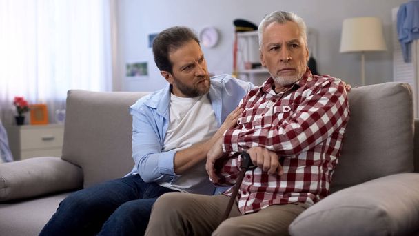 Offended senior male ignoring middle-aged son, quarrelling and misunderstanding - Photo, image