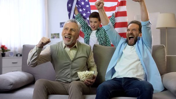 Cheerful multiage soccer fans happy with american team scoring goal, leisure - 写真・画像