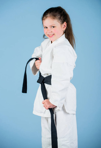 small girl in martial arts uniform. little girl in gi sportswear. practicing Kung Fu. happy childhood. knockout. energy and activity for kids. sport success in single combat. Having a little break - Fotoğraf, Görsel