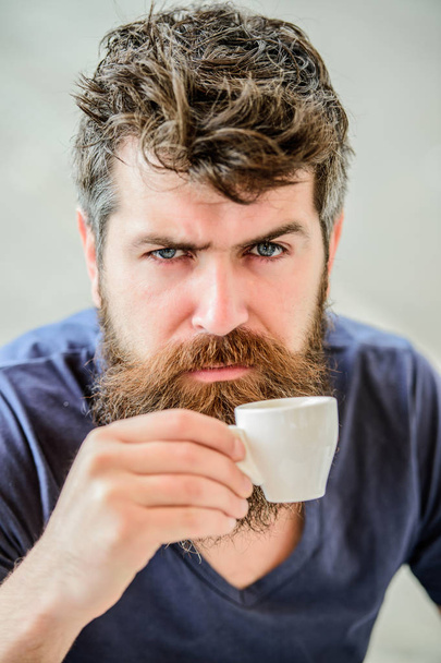 Espresso arabica only. Coffee break concept. Guy relaxing espresso. Enjoy hot drink. Hipster drinking fresh brewed coffee. Man with beard and mustache and espresso cup. Bearded guy consume caffeine - Photo, image