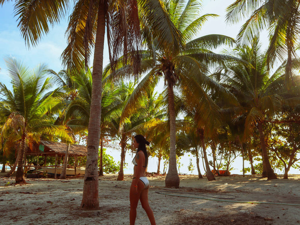 woman walking around into the palm tree jungle in Onok island in Balabac in Philippines - Fotografie, Obrázek