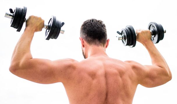 Sport lifestyle. Dumbbell exercise gym. Muscular man exercising with dumbbell rear view. Actions speak louder than coaches. Sportsman with strong back and arms. Sport equipment. Bodybuilding sport - 写真・画像