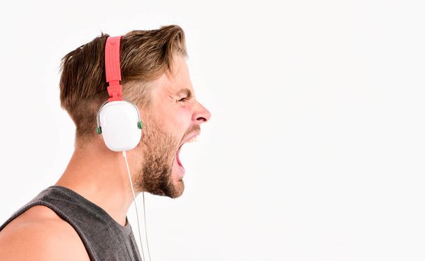 hard rock. copy space. sport music. joy and relax. sexy muscular man listen sport music. man in headset isolated on white. unshaven man in blue tooth headphones - Foto, immagini