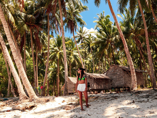 Woman in the wooden shelter surounded with palm trees in Onok Island in Balabac Philippines - Fotoğraf, Görsel