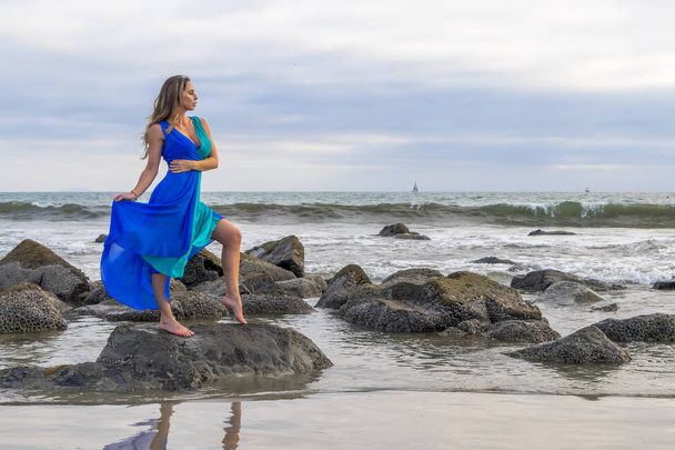Lovely Brunette Latin Model Poses Outdoors On A Beach At Sunset - 写真・画像