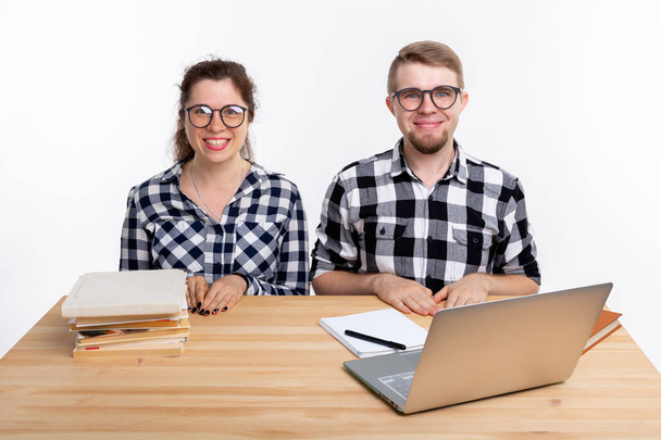 People and education concept - Two students dressed in plaid shirt sitting at a table - Foto, Imagen