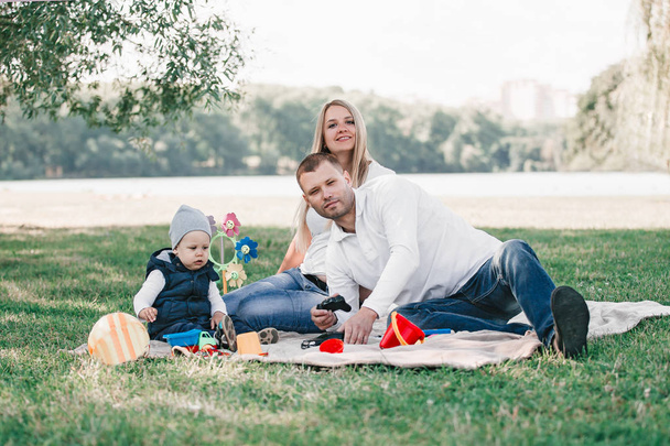 happy family sitting on the grass in the Park - Photo, image