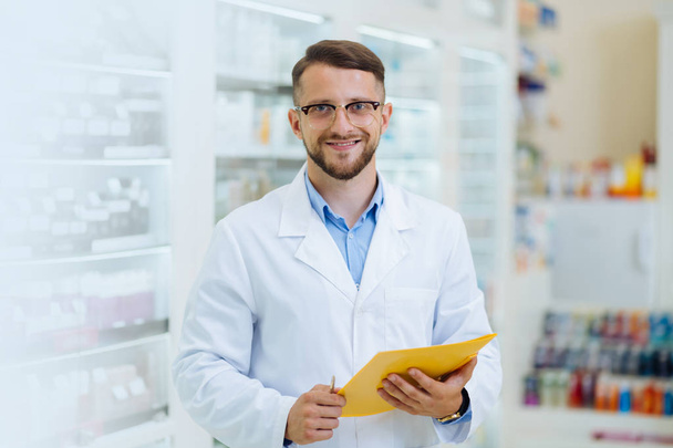 Joyful bearded chemist working in drug store - Foto, Imagem
