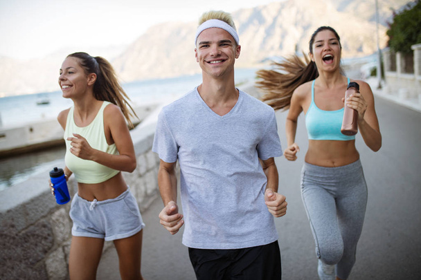 Group of happy young people friends running outdoors at seaside - Φωτογραφία, εικόνα