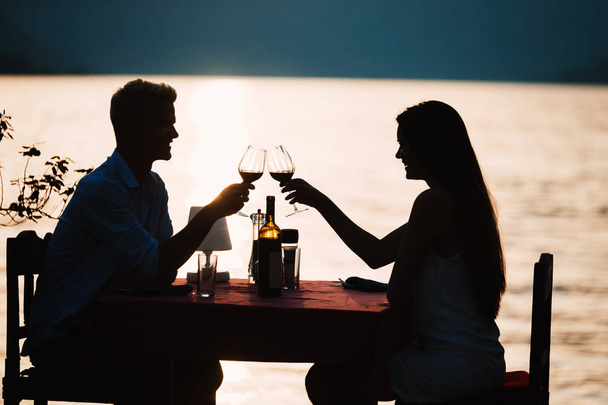 Young romantic couple toasting during dinner on tropical resort - Foto, Bild