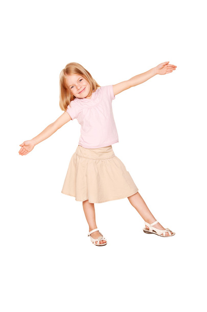 Happy little girl dancing. Isolated on white - Foto, afbeelding