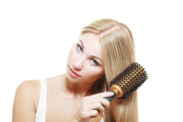 blond young brushing her hair - Foto, Bild