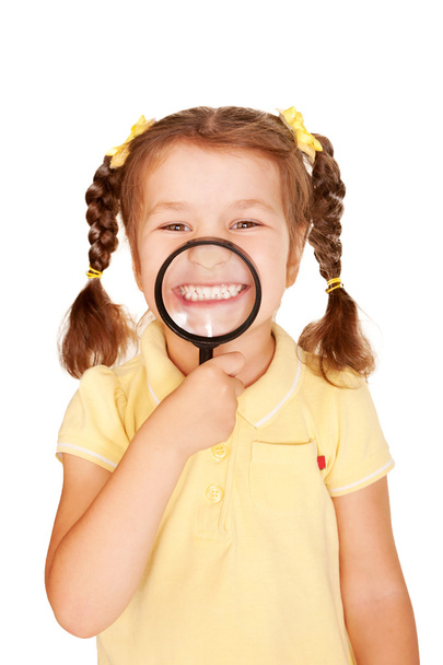 Little girl smiling through magnifying glass. - Valokuva, kuva