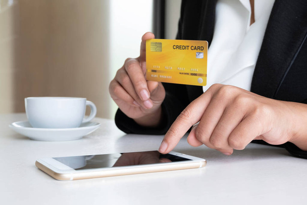 Business woman consumer holding credit card and smartphone for online shopping and payment make a purchase on the Internet - Photo, Image