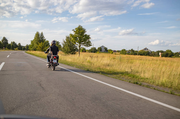 Motorcyclist biker driving on the highway - Foto, imagen
