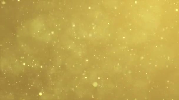 Brillante fondo de oro con partículas brillantes que fluyen alrededor, la magia navideña bokeh estrellas volando en el espacio
 - Metraje, vídeo