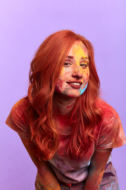 girl with beautiful long red hair boasting about her painted face - 写真・画像
