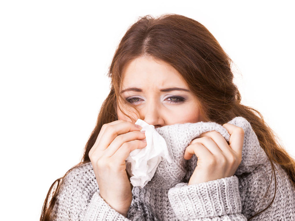 Sick freezing woman sneezing in tissue - 写真・画像