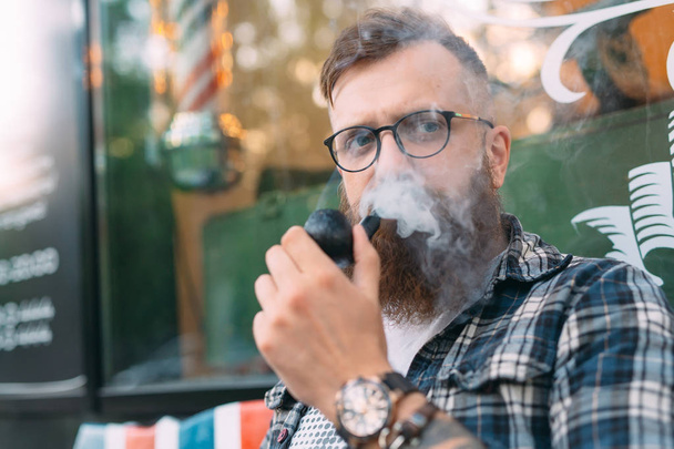 Portrait of man sitting and smoking pipe. - Foto, Imagem
