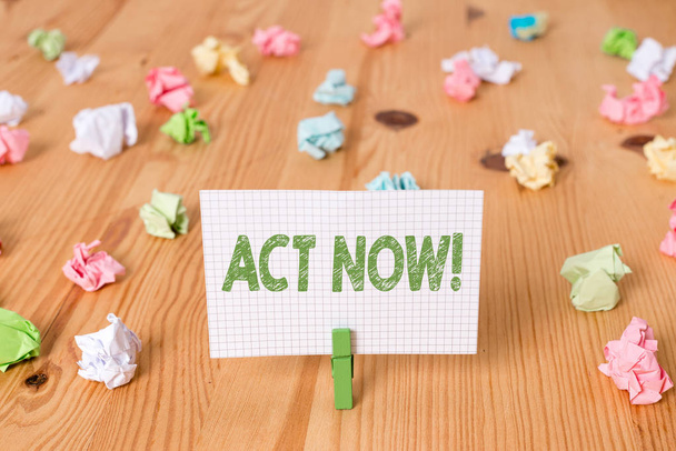 Conceptual hand writing showing Act Now. Business photo showcasing do not hesitate and start working or doing stuff right away Colored crumpled papers wooden floor background clothespin. - Photo, Image