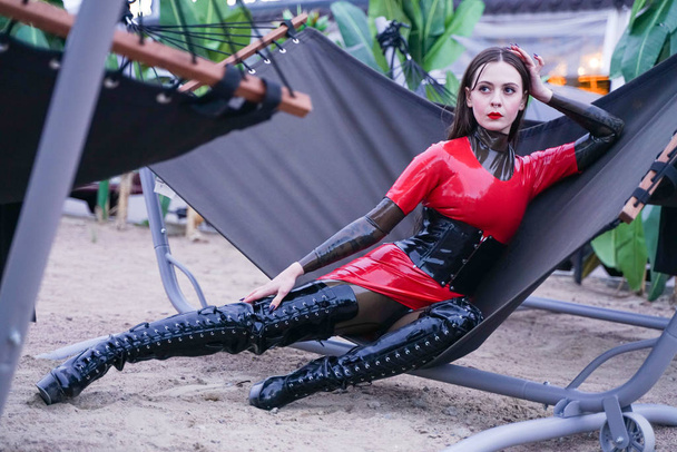 fashion stylish lady wear latex rubber clothes on the beach outdoor - Photo, Image
