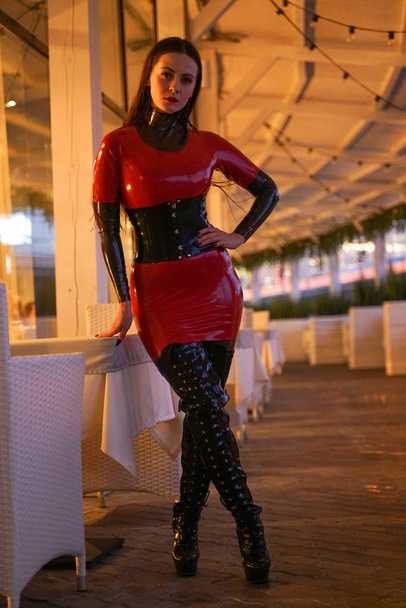 brave girl in latex walks in public and shows her exhibitionism - Photo, Image