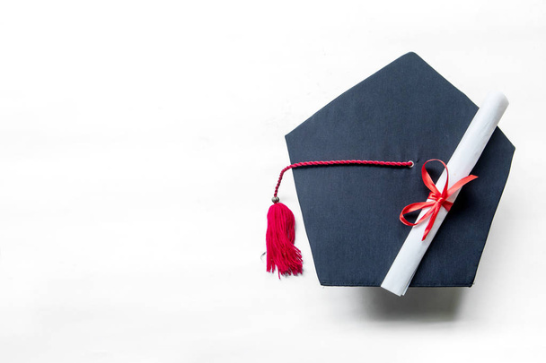 Graduation hats and diploma on the table - Valokuva, kuva