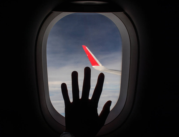 A hand over the window of airplane - Photo, Image