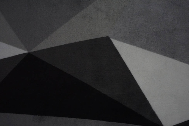 parede de concreto cinza com sombras e formas de triângulos
  - Foto, Imagem