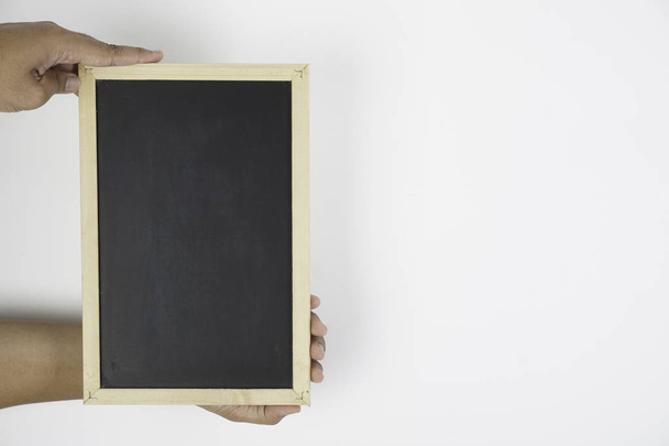 hand holding black board over white background - Φωτογραφία, εικόνα