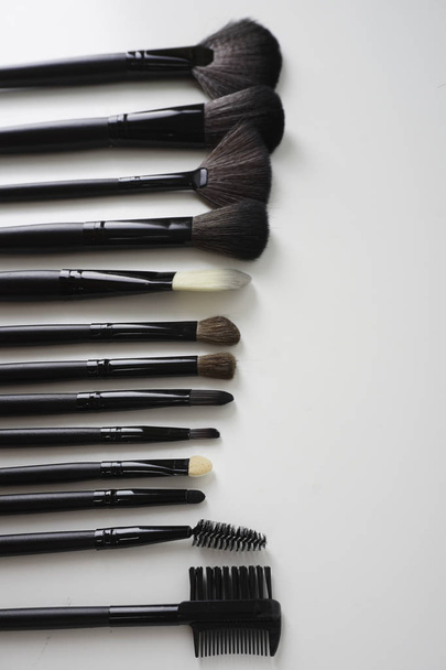 set of black make up brushes over pink background - Zdjęcie, obraz