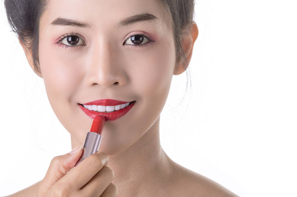 Beautiful Young Asian Woman using Libstick and Cosmetic on own f - Фото, зображення
