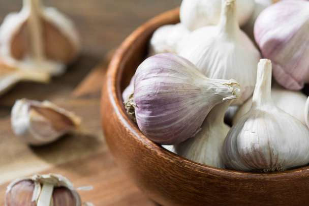 Garlic on a grey wooden table. Rustic style - Foto, afbeelding