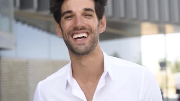 Young man smiling to camera wearing casual clothes with modern hairstyle. - Felvétel, videó