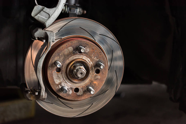 Disc brake and asbestos brake pads at car garage - Photo, Image