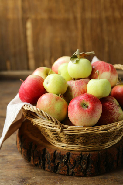 organic apples in a wicker basket on the table - Φωτογραφία, εικόνα