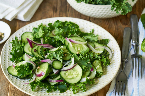Salad with kale, cucumbers and red onions                                - Photo, Image