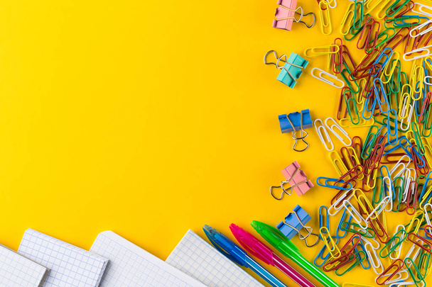 Colorful paper clips and binder clips on yellow background, copy space - Φωτογραφία, εικόνα
